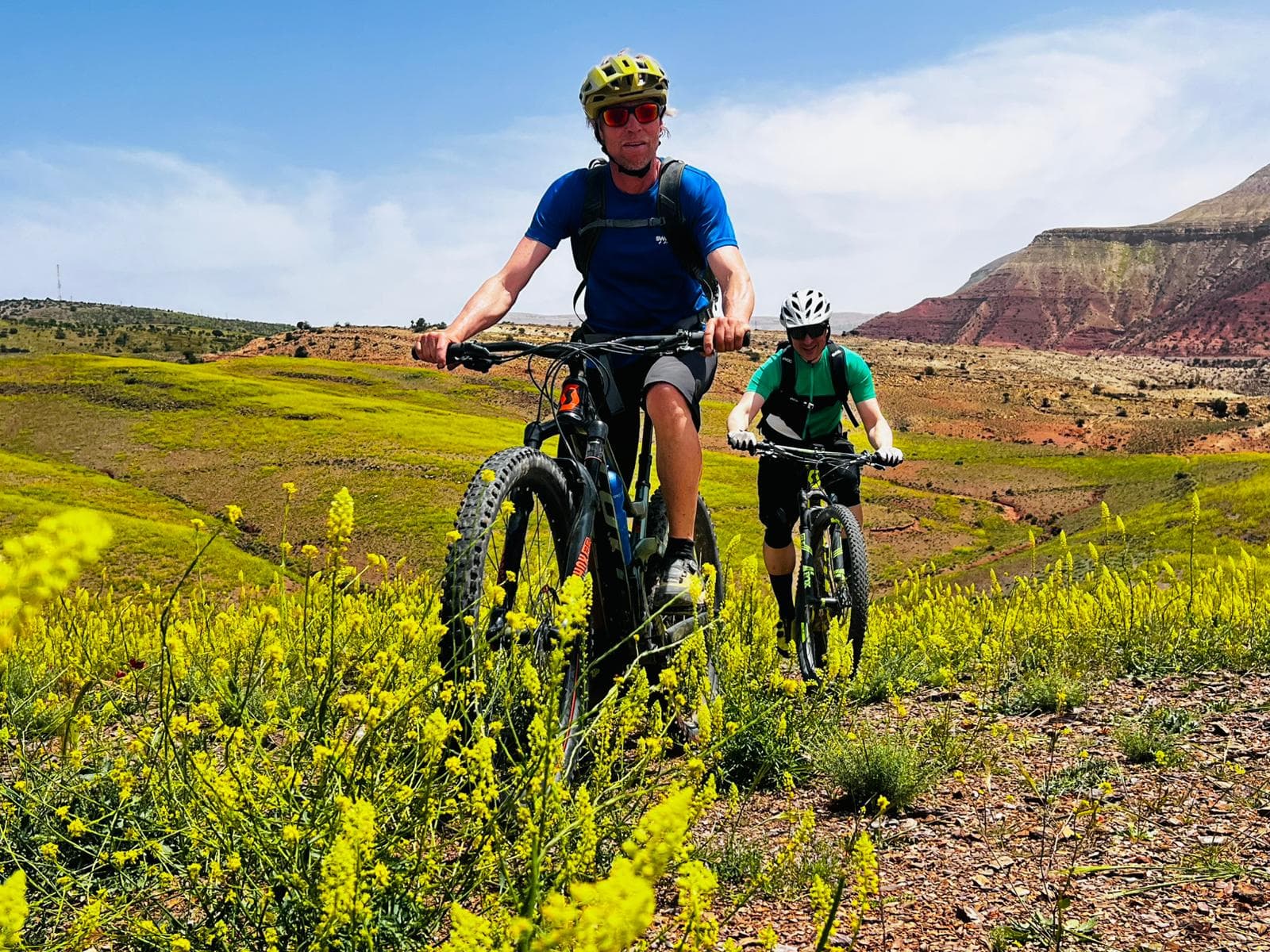 Mountain bikers riding a green singletrack in the Happy Valley