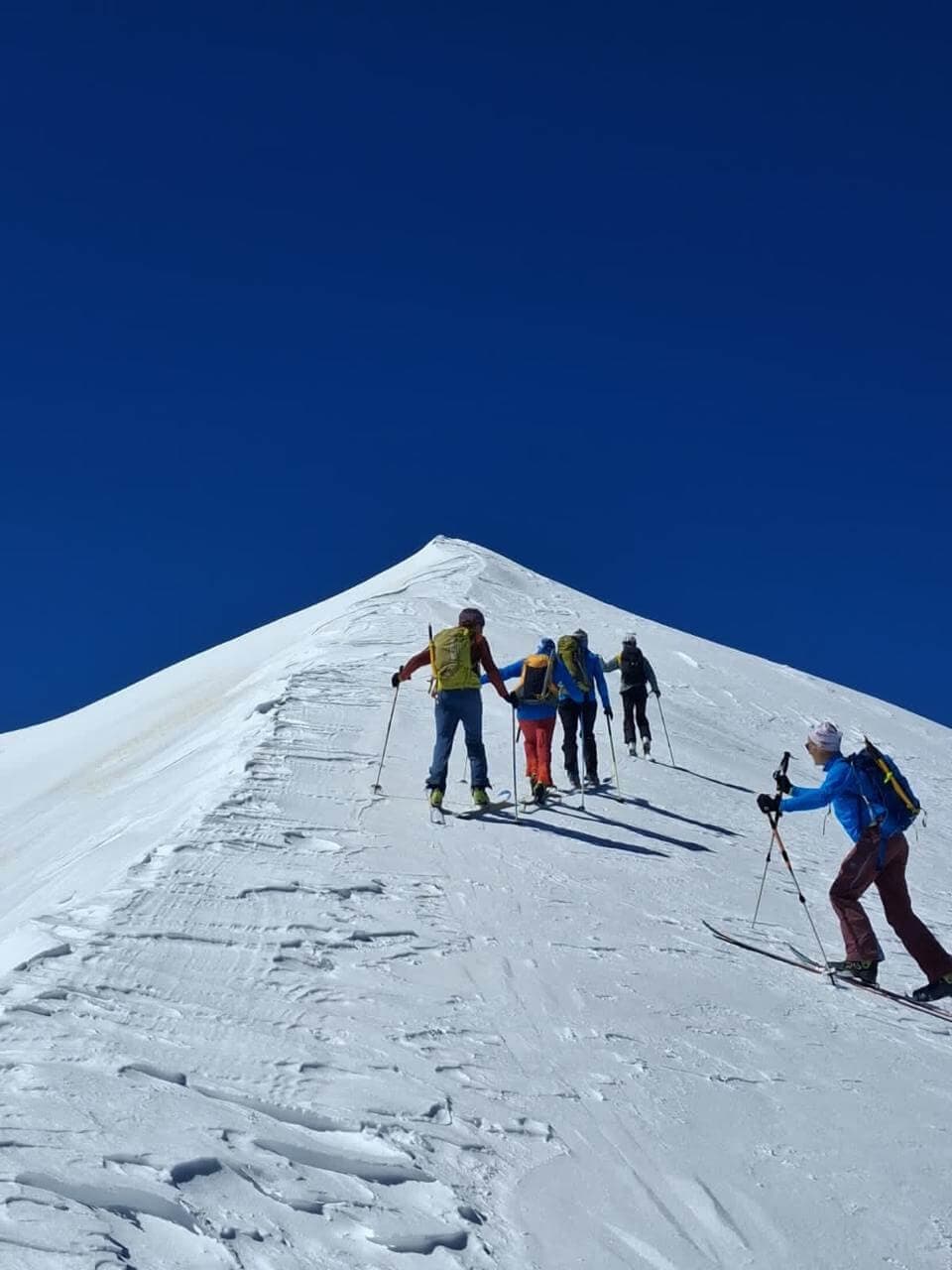 Skiers climbing a snow-covered slope in the High Atlas