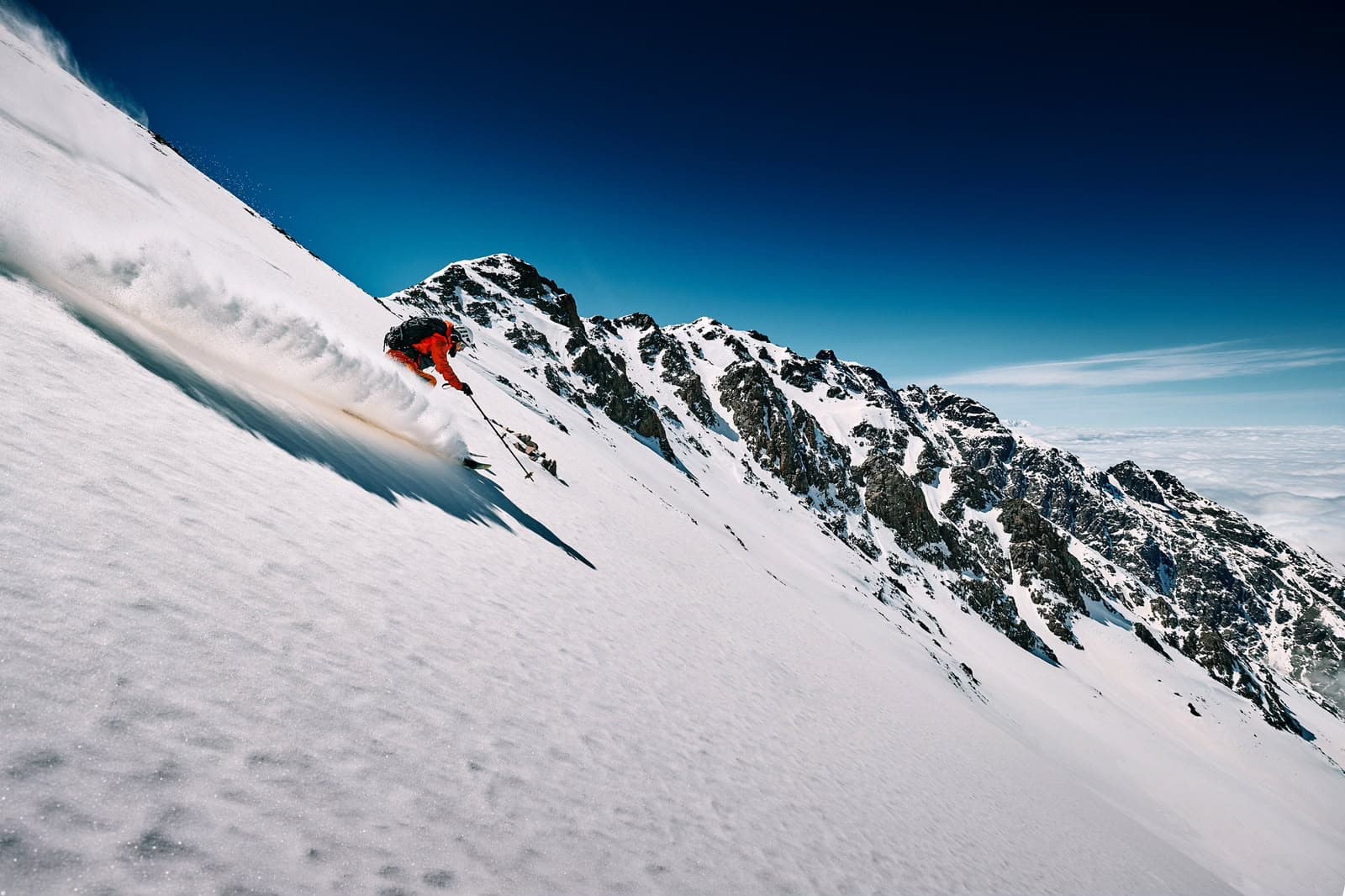 Ski tourer descending a mountain in the Moroccan Atlas